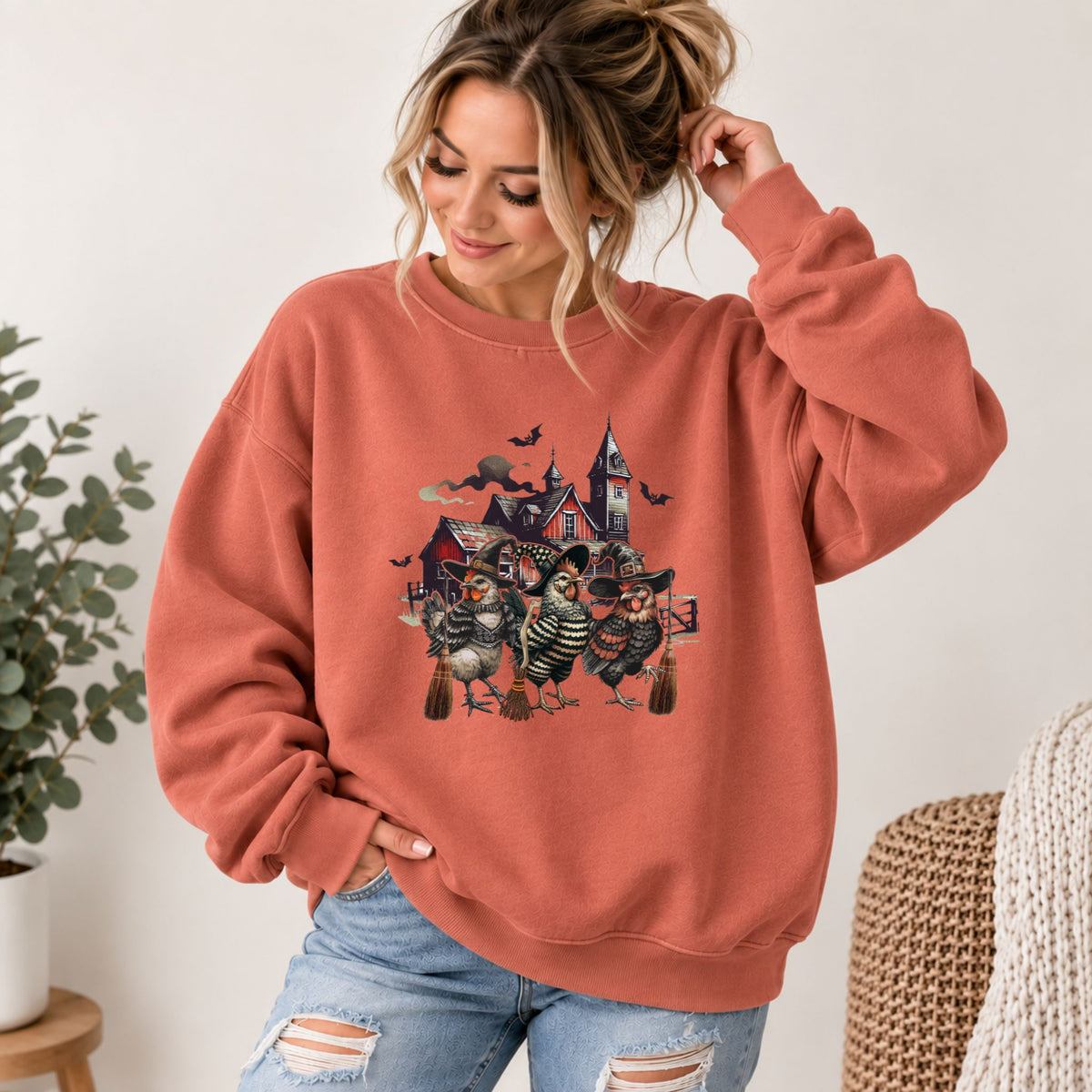 Rust-orange Comfort Colors sweatshirt with witchy chicken house graphic, crew neckline