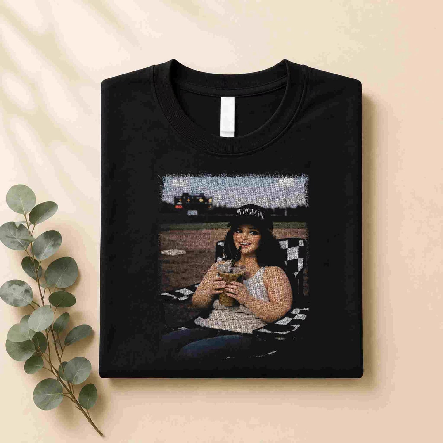 The Softball Mom Iced Coffee Bleacher Queen Graphic Tee by Becca's Banging Designs LLC is a stylish women’s shirt featuring a fun softball mama graphic—perfect for those seeking affordable, trendy tees.