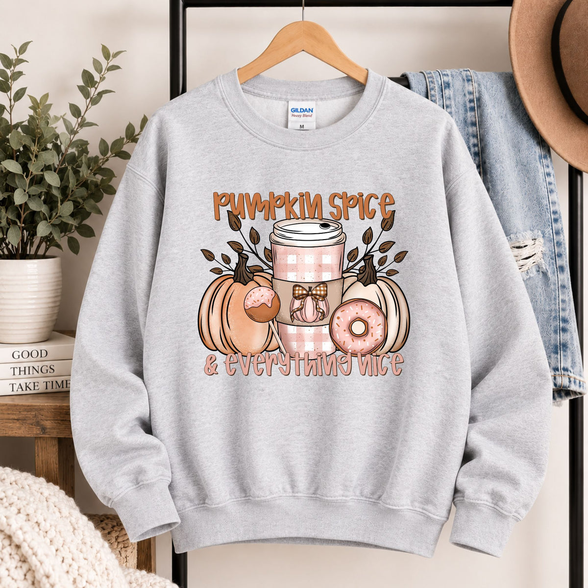 Light gray sweatshirt on hanger with pumpkin spice and everything nice front design