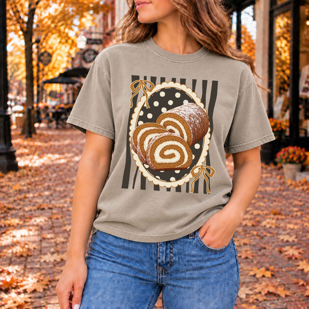Warm gray graphic tee printed with a powdered pumpkin roll and two cream-swirl slices