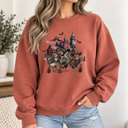 Rust-orange sweatshirt with witchy chicken and haunted house graphic, crew neck