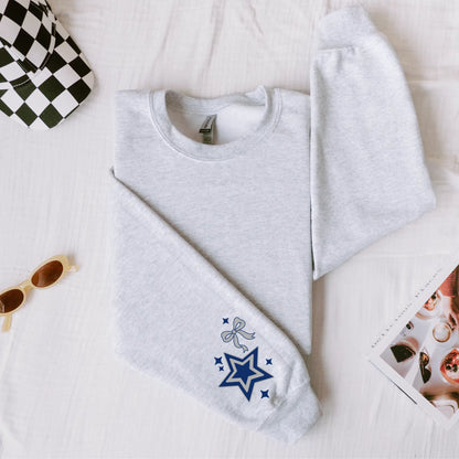 Dallas Cowboys Star Sweatshirt: Football Game Day Apparel, Accessories: Sunglasses, Checkered Hat & Magazine on White Fabric.