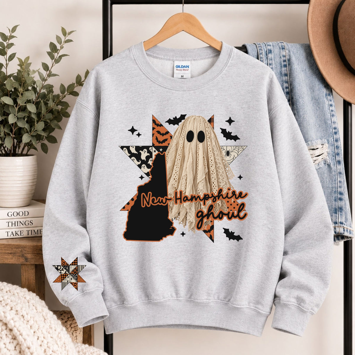 Light gray crewneck sweatshirt with New Hampshire ghoul state graphic and burlap ghost hood