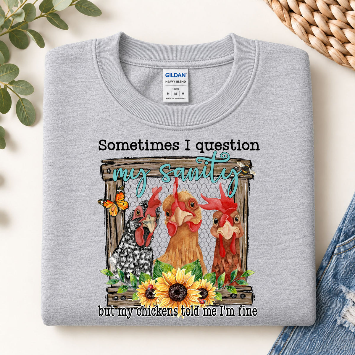 Grey crewneck sweatshirt with colorful chicken graphic front print and text message.