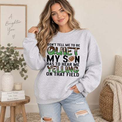 Grey crewneck sweatshirt on female model, featuring "QUIET" football-themed "MY SON" slogan