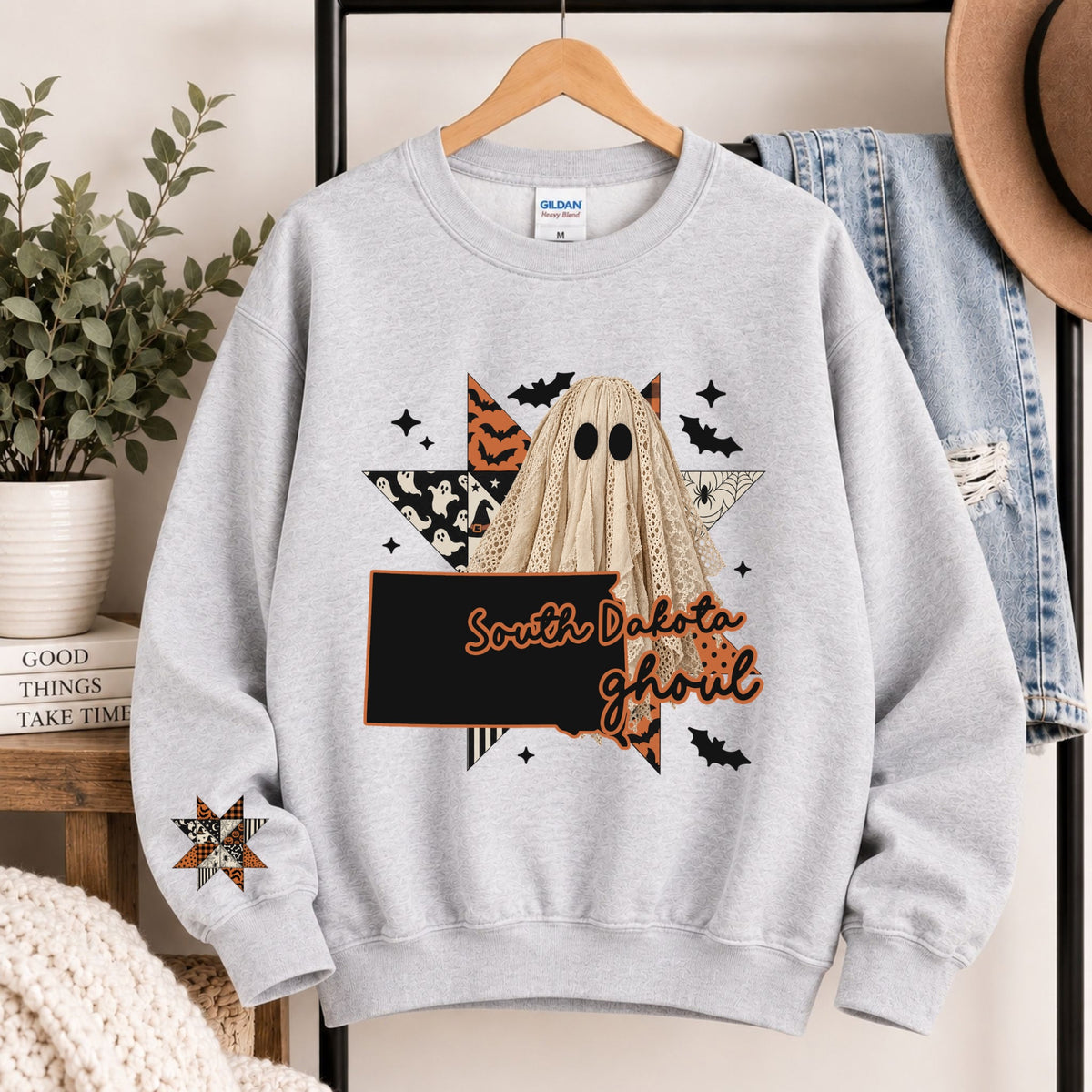 Light gray crewneck sweatshirt with South Dakota ghoul graphic and state silhouette