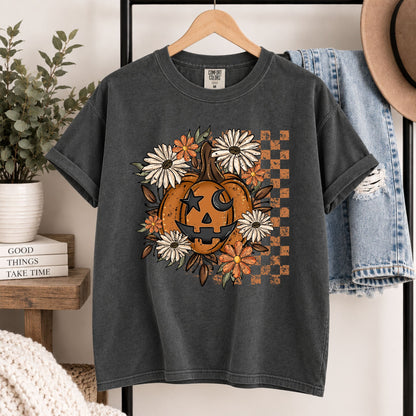 Dark gray Halloween T-shirt hanging on hanger with orange jack-o'-lantern floral graphic