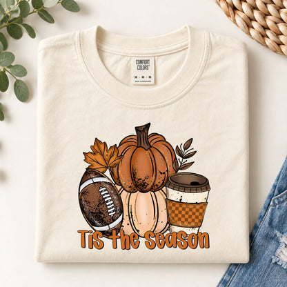 Cream graphic tee with orange pumpkin, acorns, and “Tis the Season” text