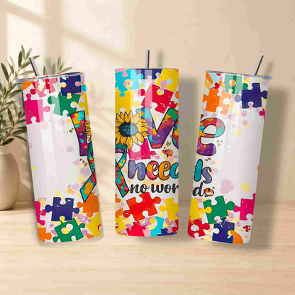 The Autism Awareness Love Needs No Words Tumbler – 20oz by Becca's Banging Designs LLC features vibrant puzzle piece and sunflower patterns, making it a perfect autism support gift.