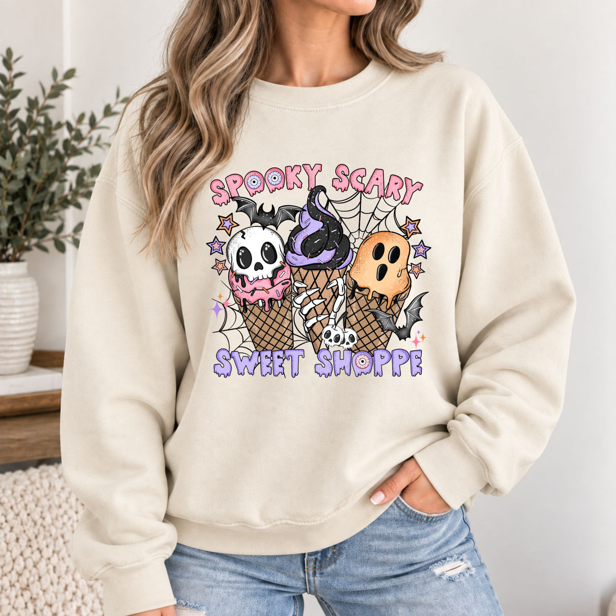 Cream crewneck Halloween sweatshirt with skull-and-ice-cream front graphic