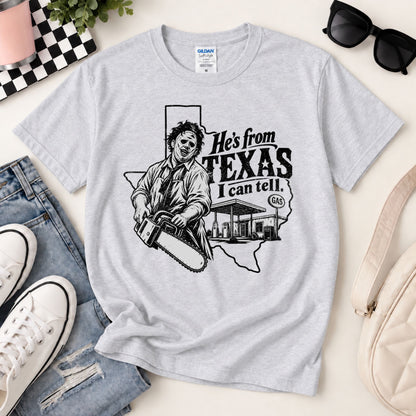 Light heather gray horror graphic T-shirt laid flat with chainsaw Texas text print