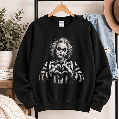 Black crewneck sweatshirt hanging with monochrome portrait graphic on the front