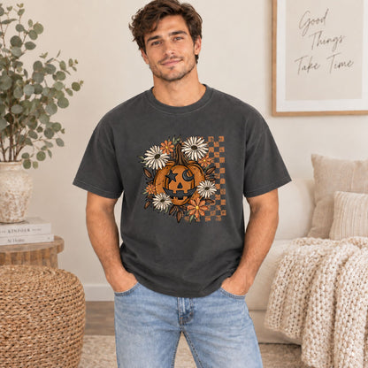 Dark gray Halloween T-shirt on model with orange jack-o'-lantern floral center graphic