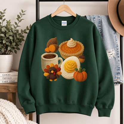 Green crewneck sweatshirt hanging with crocheted Thanksgiving graphic of mug, pie, and turkey