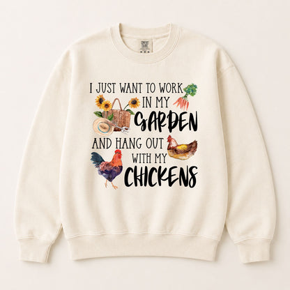 Cream crewneck sweatshirt with garden and chicken text graphic, flat lay, long sleeves.