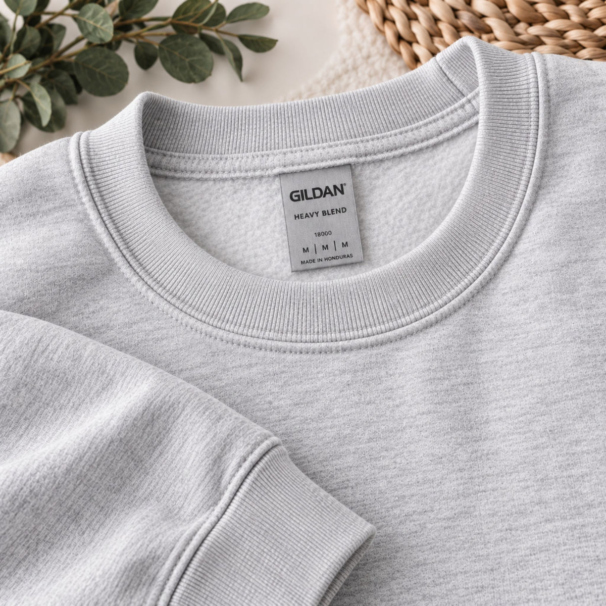 Close-up of grey sweatshirt neckline with Gildan size label on inside collar.