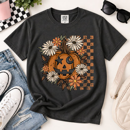 Black/dark gray Halloween T-shirt with orange jack-o'-lantern floral wreath and checker box