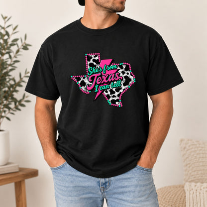 Black graphic T-shirt with dotted Texas outline and “She’s from Texas I can tell” text