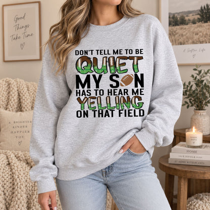 Grey sweatshirt on female model, featuring "QUIET" and "MY SON" football text design