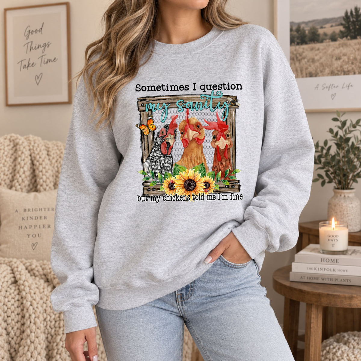 Grey crewneck sweatshirt on model with front chicken illustration and quote text print.