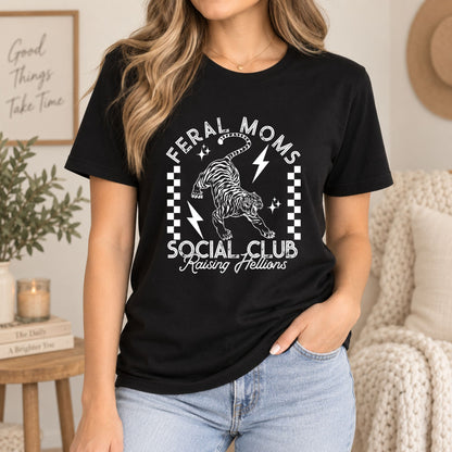 Black graphic T-shirt with cat skull lightning and 'Feral Moms Social Club'