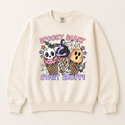 Cream pullover sweatshirt with centered Halloween graphic of skulls and ice-cream cones