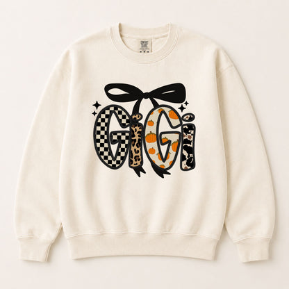Cream crewneck sweatshirt with black bow and fall letter graphic featuring checkered and leopard.