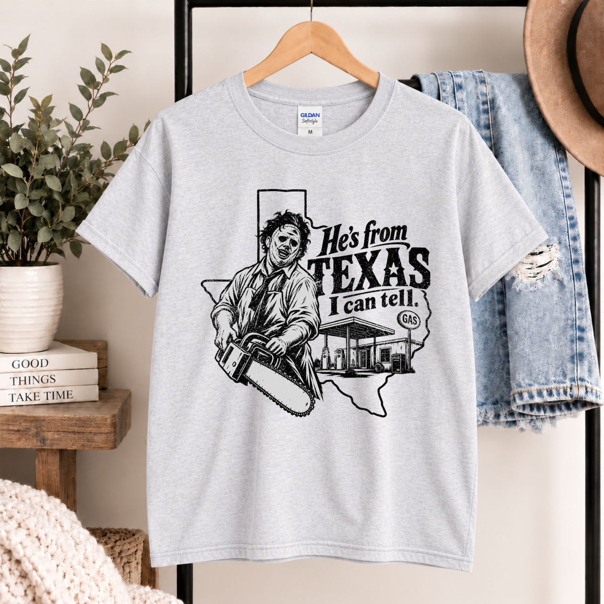 Heather gray horror graphic T-shirt on hanger with Texas chainsaw character design