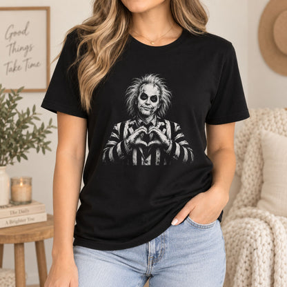 Black T-shirt with front graphic of a black-and-white spooky character and heart hands