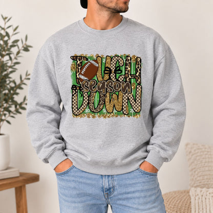 Light gray crewneck sweatshirt with large “Touchdown Season” leopard camo football graphic.