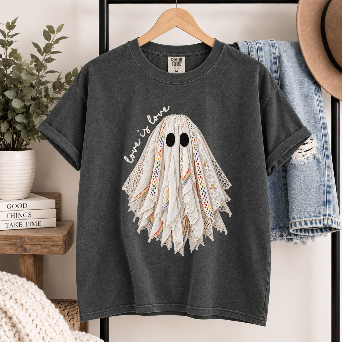 Dark gray graphic tee on wooden hanger with layered lace ghost face design