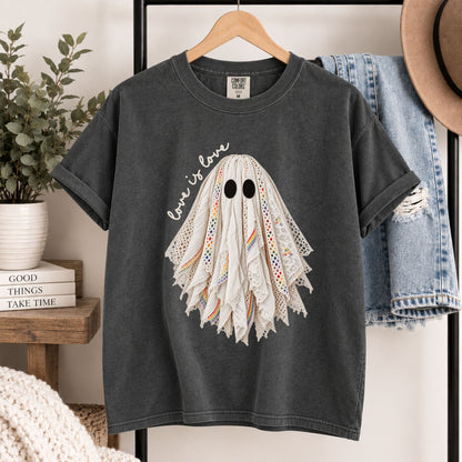 Dark gray graphic tee on wooden hanger with layered lace ghost face design