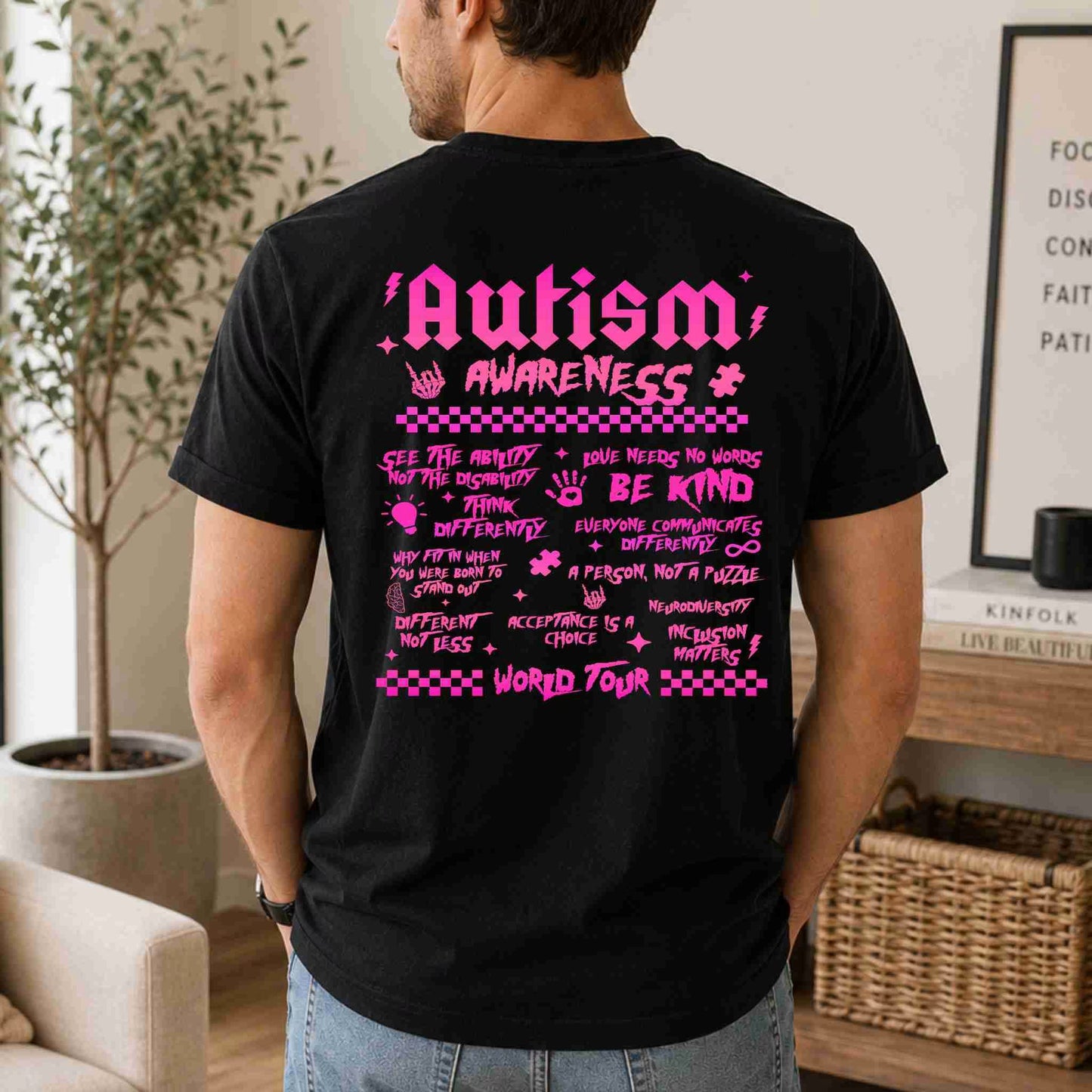 Person wearing a black t-shirt with pink 'Autism Awareness' text and graphics.