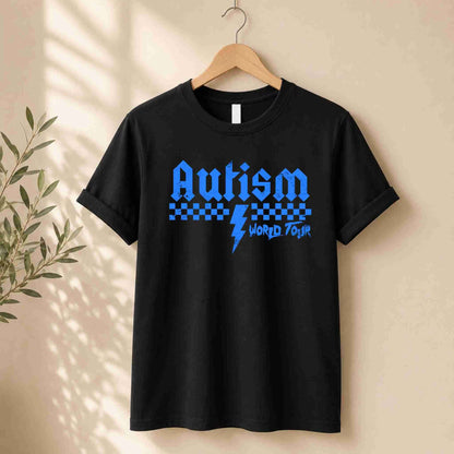 Black t-shirt with blue 'Autism World Tour' design on a hanger against a beige wall.