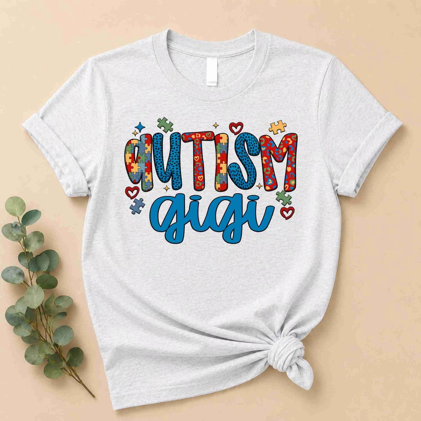 Ash Grey t-shirt with 'Autism Gigi' text on a beige background