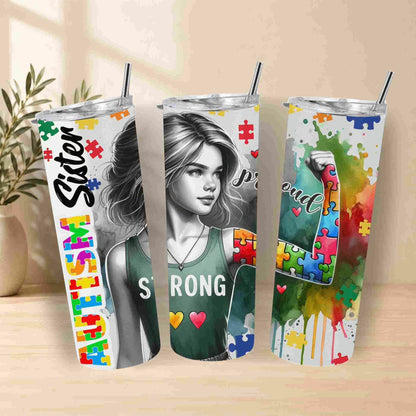 Three tumblers with autism awareness designs on a wooden surface.