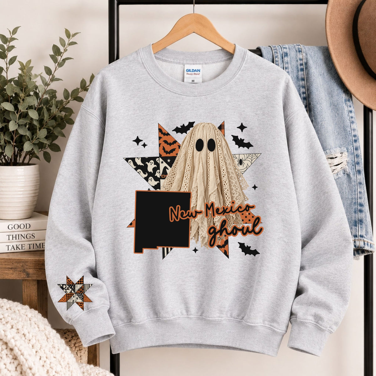 Light gray crewneck sweatshirt with hooded ghost and New Mexico ghoul graphic
