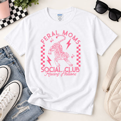 White graphic tee with pink “Feral Moms Social Club” unicorn lightning screenprint