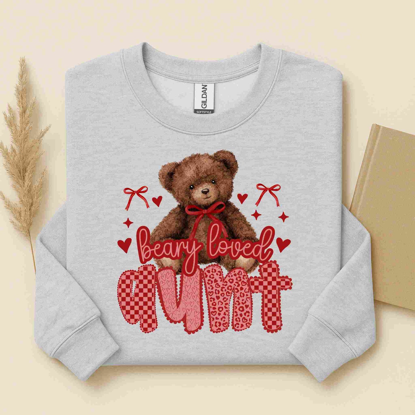 Gray sweatshirt with a teddy bear graphic and text on a beige background