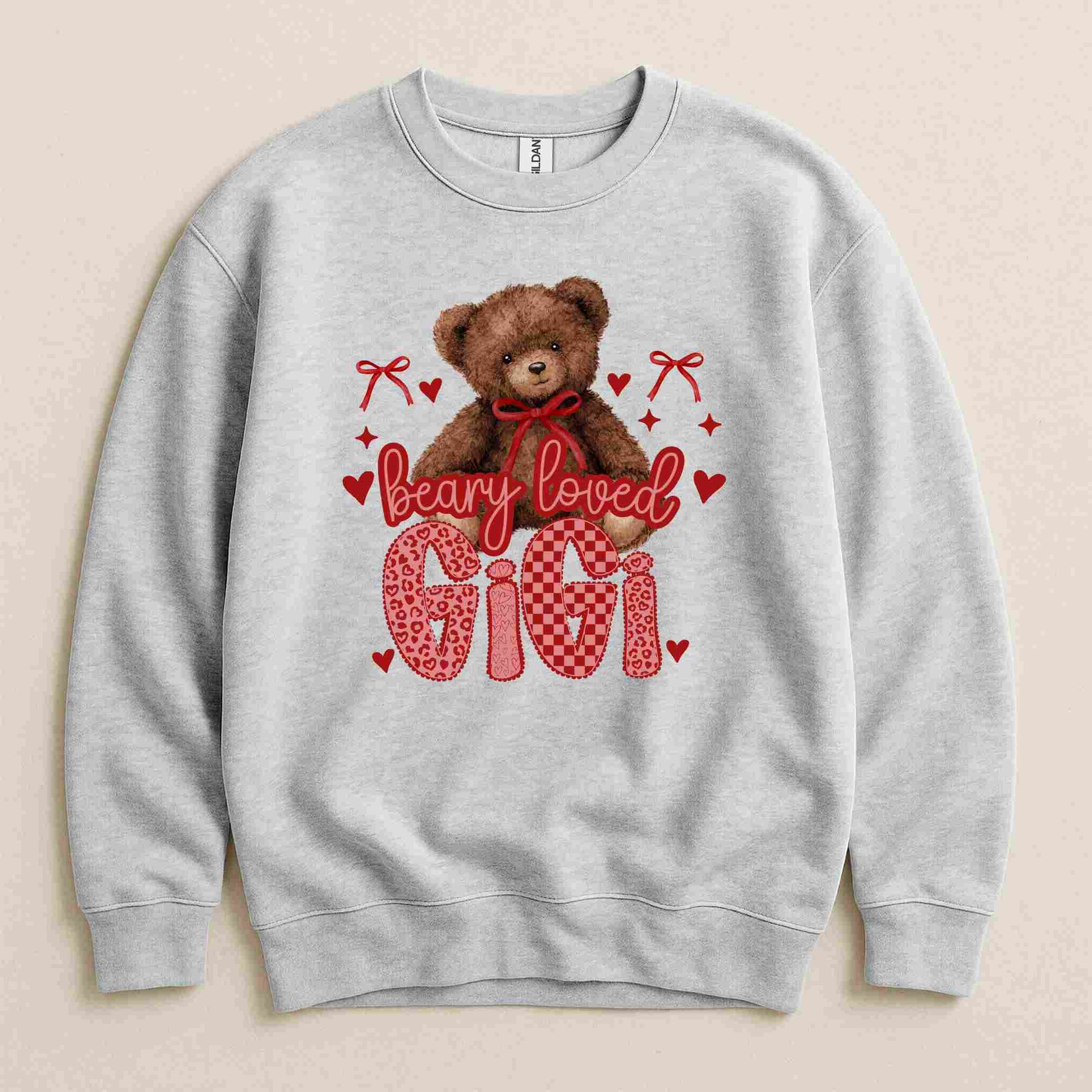 Gray sweatshirt with a teddy bear graphic and 'bearly loved Gigi' text on a beige background