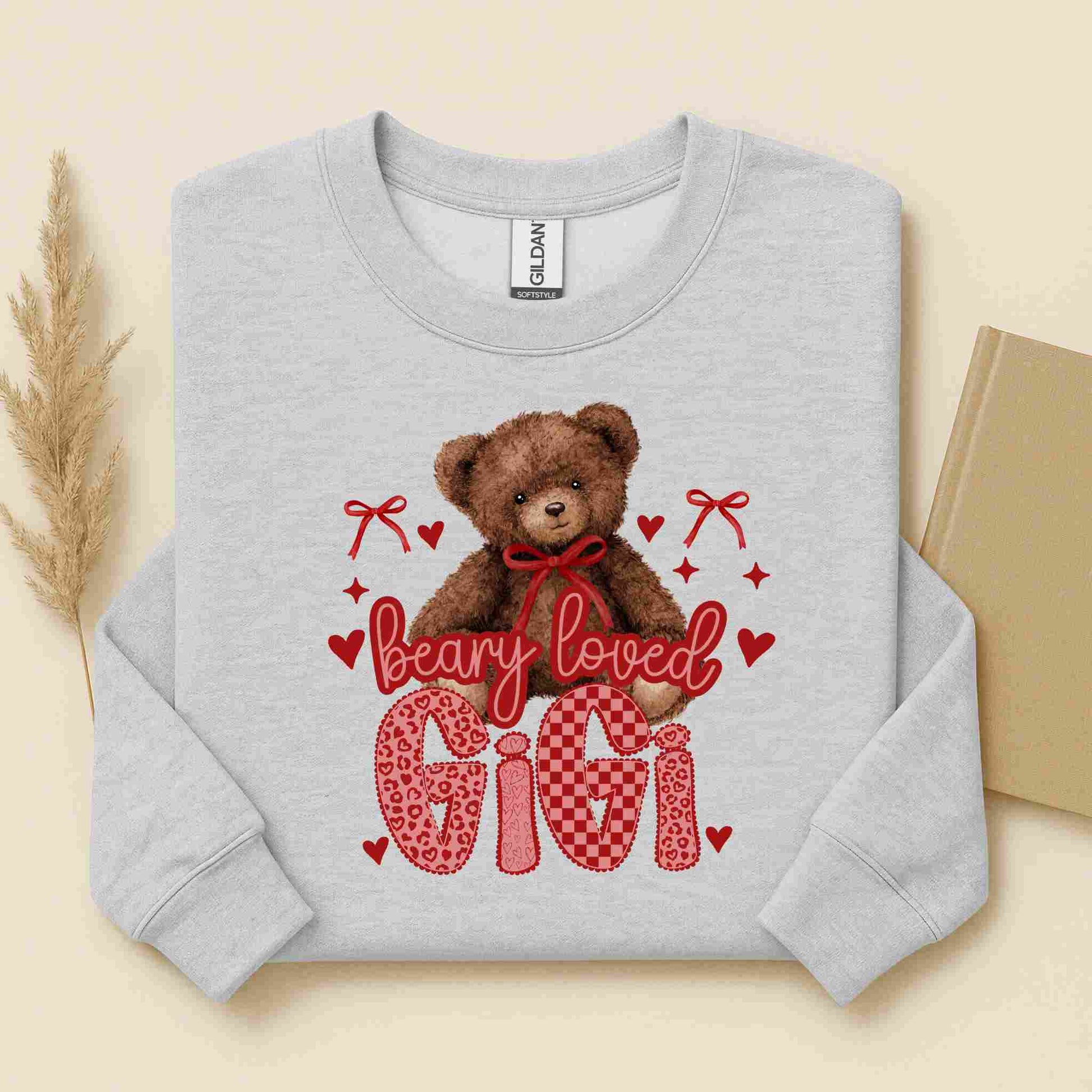 Gray sweatshirt with a teddy bear graphic and text on a beige background