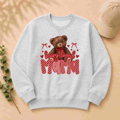Gray sweatshirt with a teddy bear graphic and 'bearly loved mama' text on a beige background.