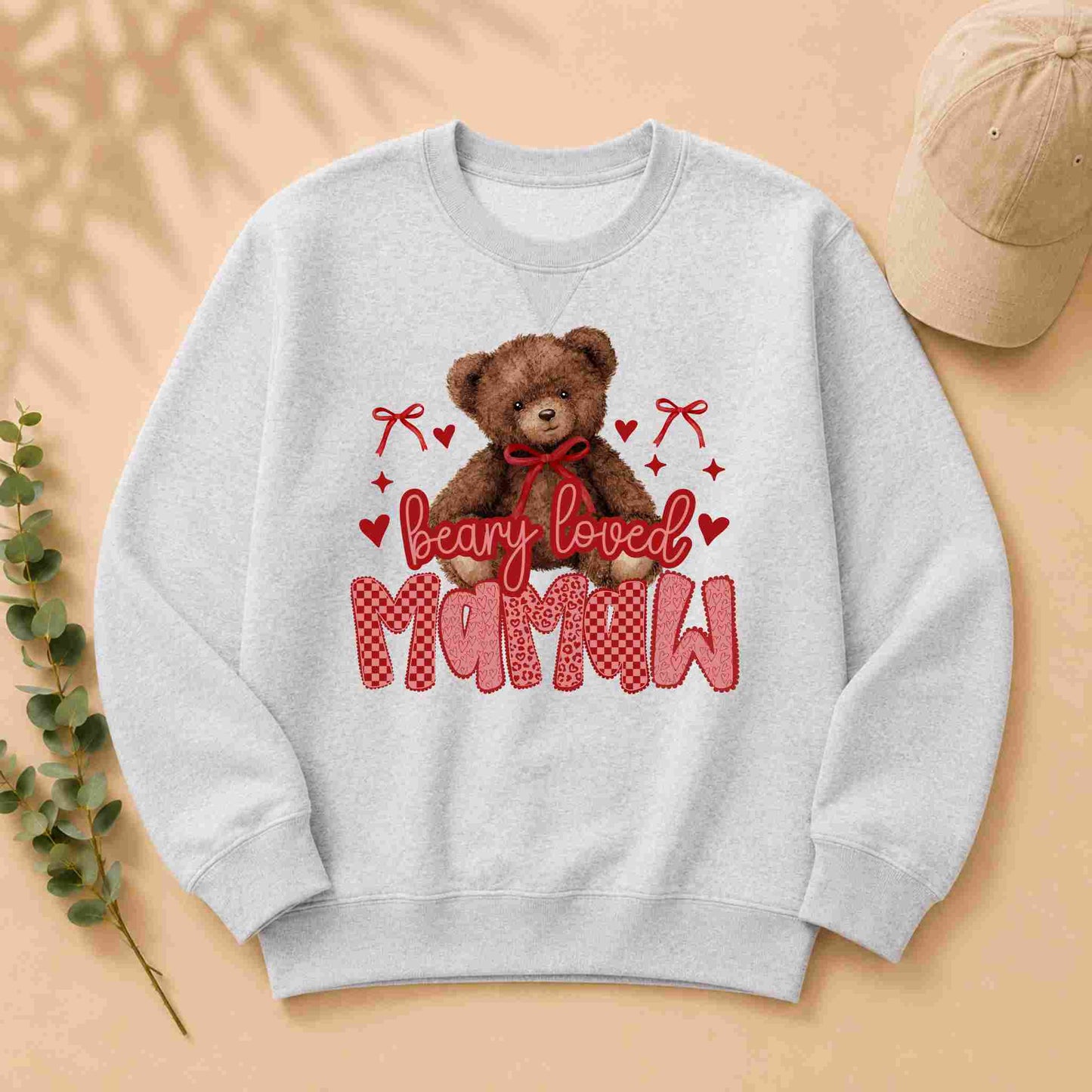 Gray sweatshirt with a teddy bear graphic and 'bearly loved mamaw' text on a beige background.
