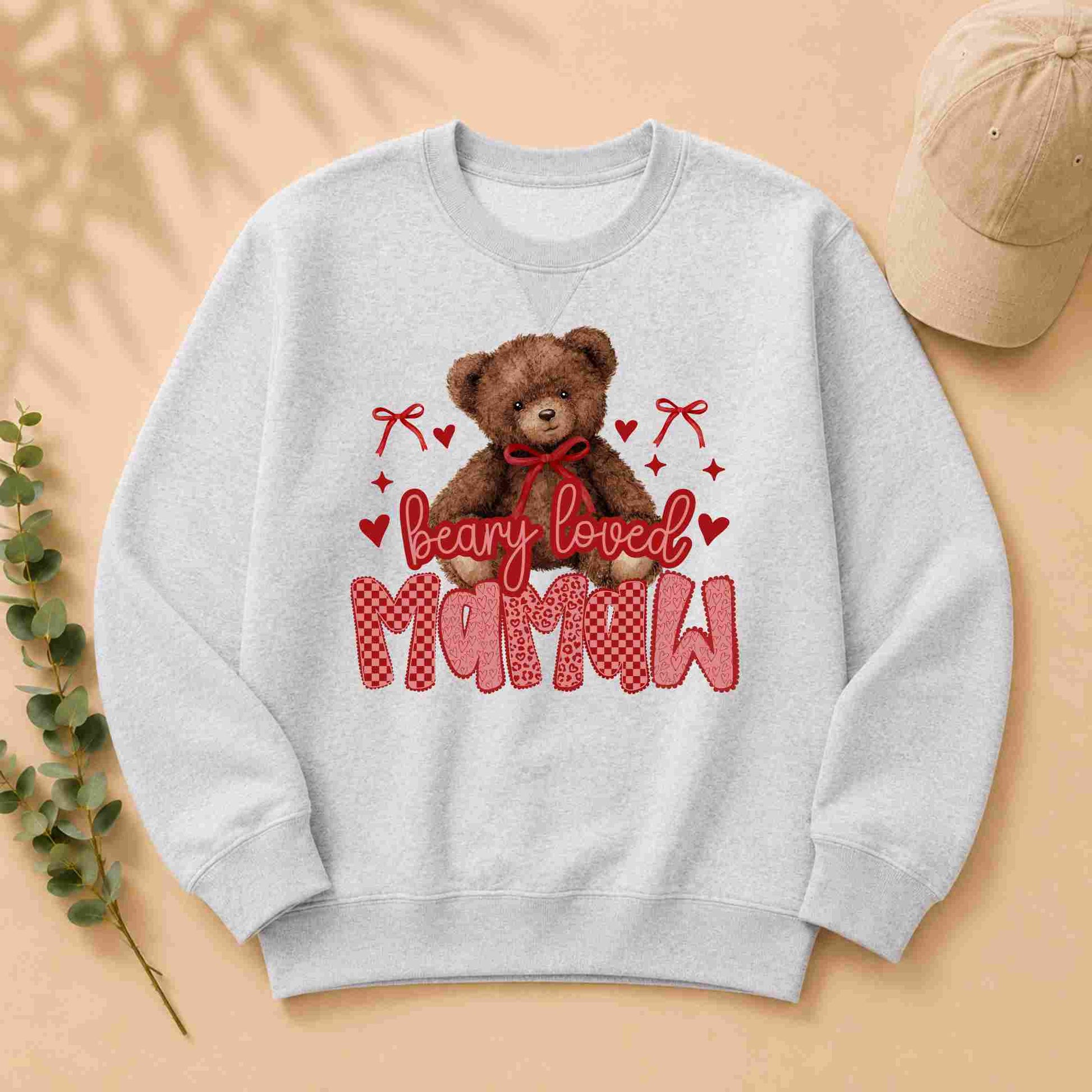 Gray sweatshirt with a teddy bear graphic and 'bearly loved mamaw' text on a beige background.