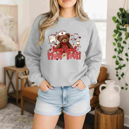 Person wearing a gray sweatshirt with a teddy bear graphic and text in a home setting