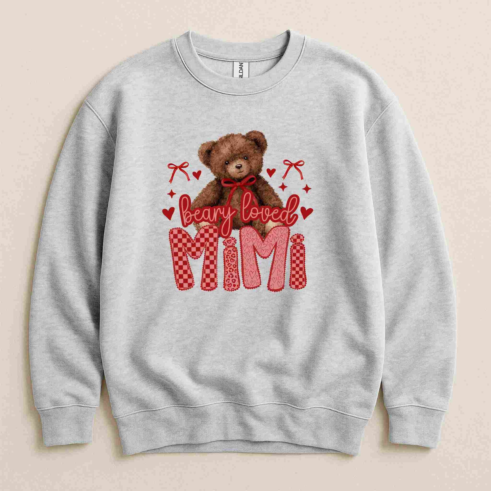 Gray sweatshirt with a teddy bear and 'Beary Loved Mimi' text on a beige background