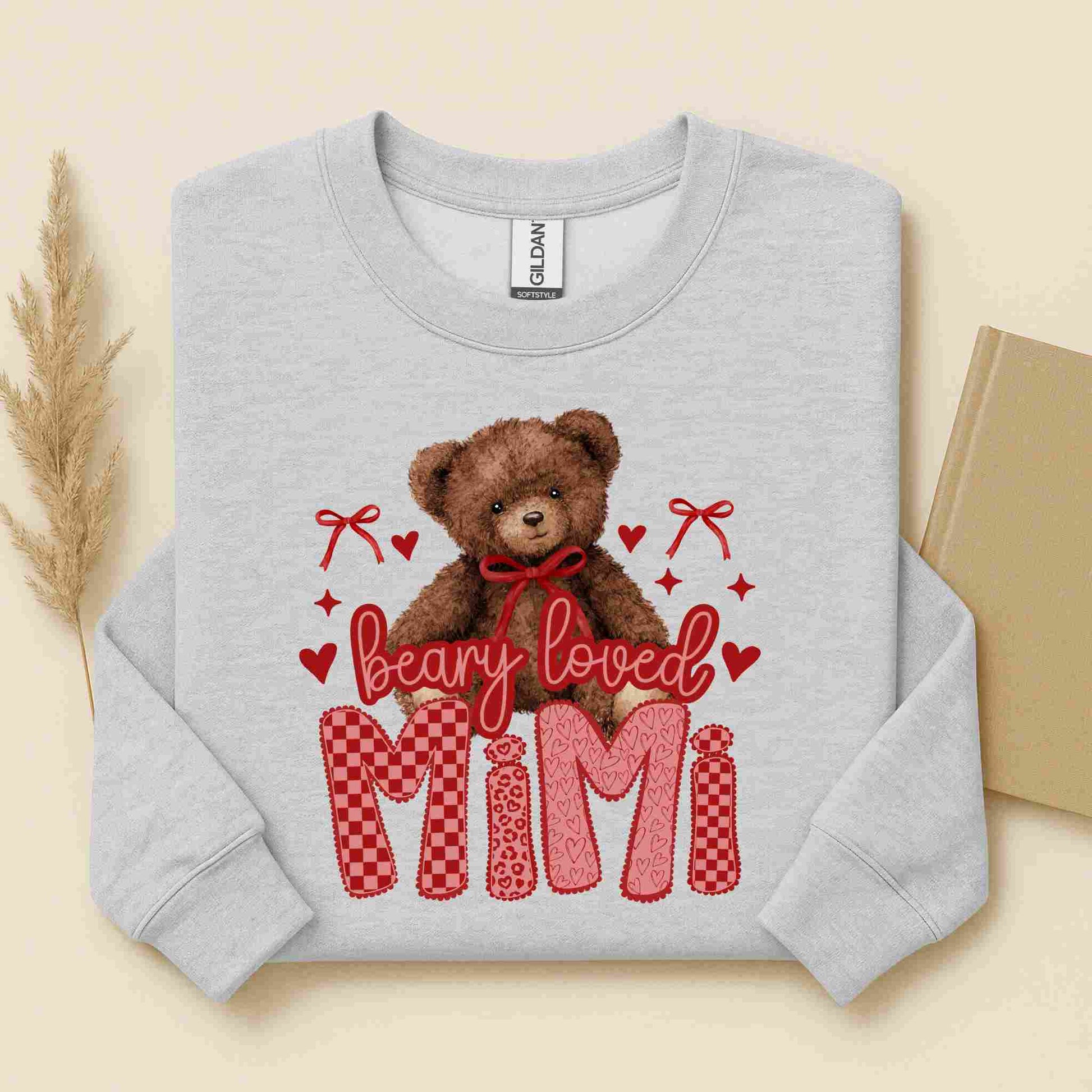 Gray sweatshirt with a teddy bear and 'bearly loved MIMI' text on a beige background
