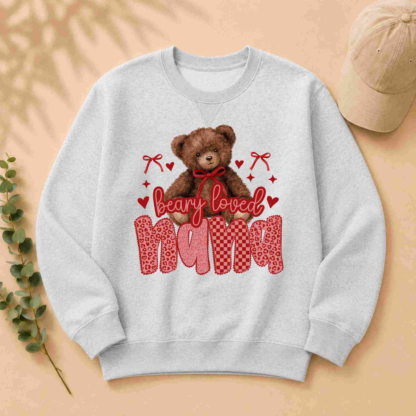 Gray sweatshirt with a teddy bear graphic and 'bearly loved nana' text on a beige background.