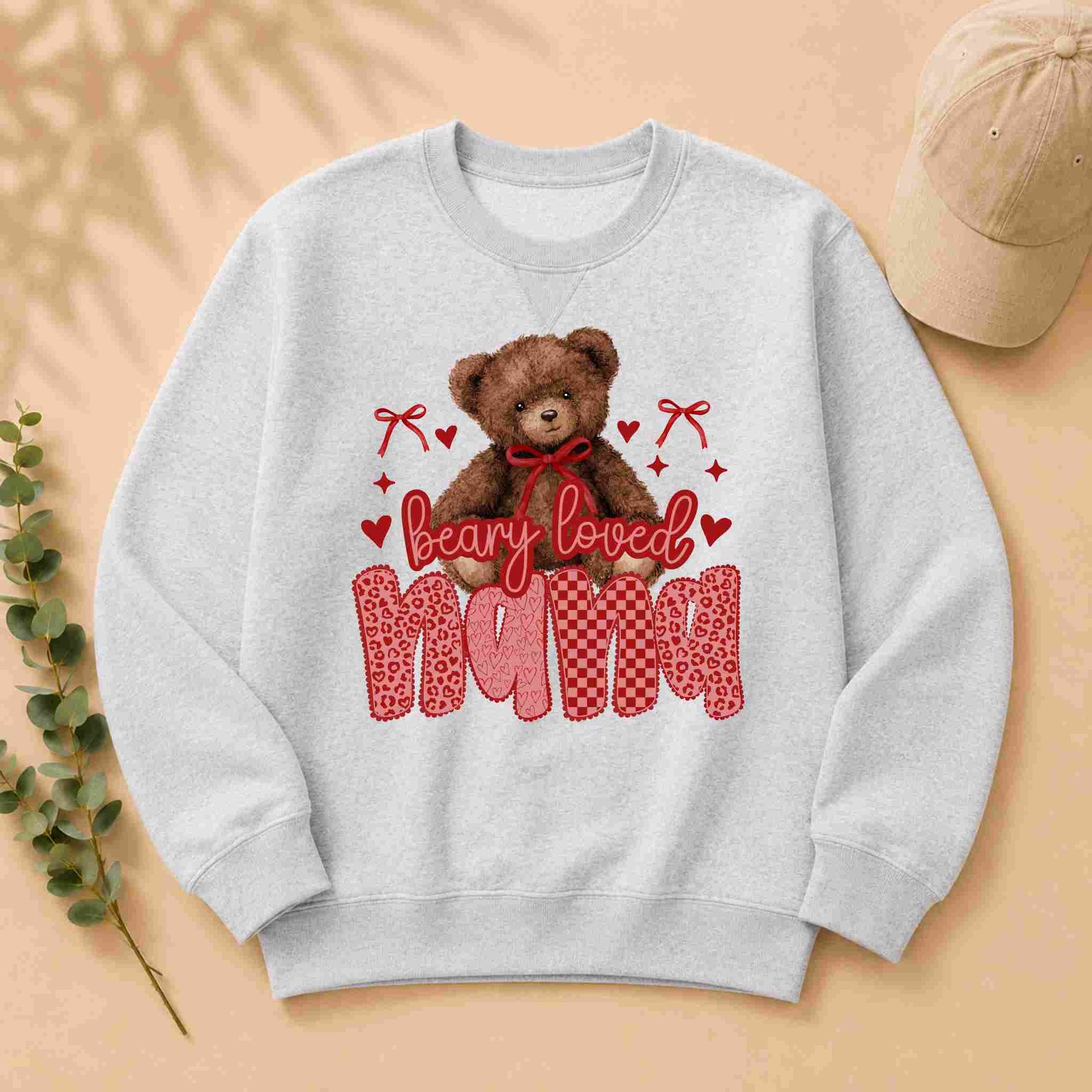 Gray sweatshirt with a teddy bear graphic and 'bearly loved nana' text on a beige background.