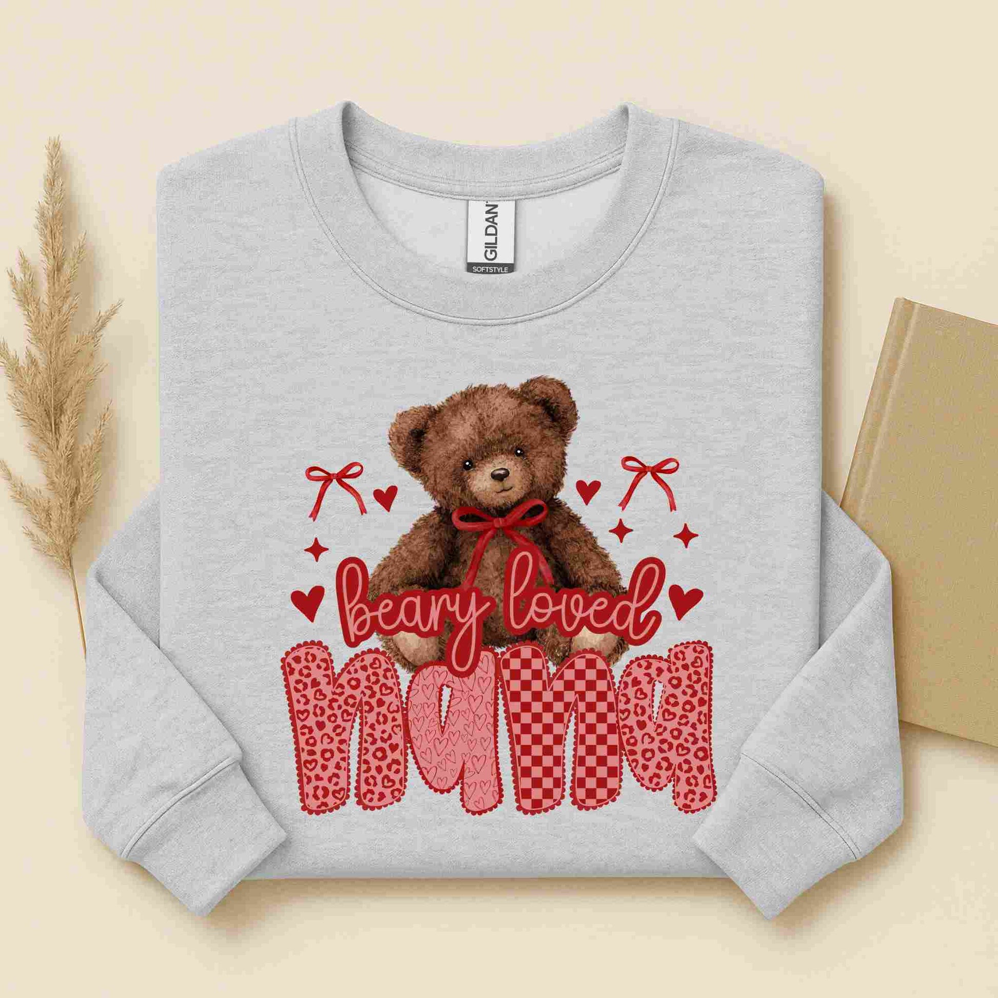 Gray sweatshirt with a teddy bear and text design on a beige background
